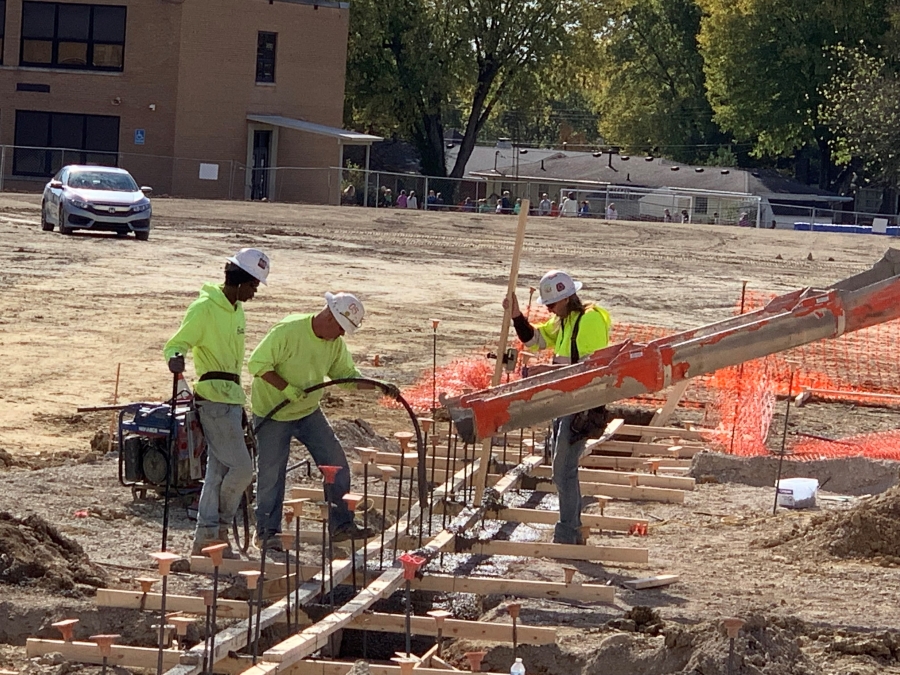 pouring concrete into footer molds